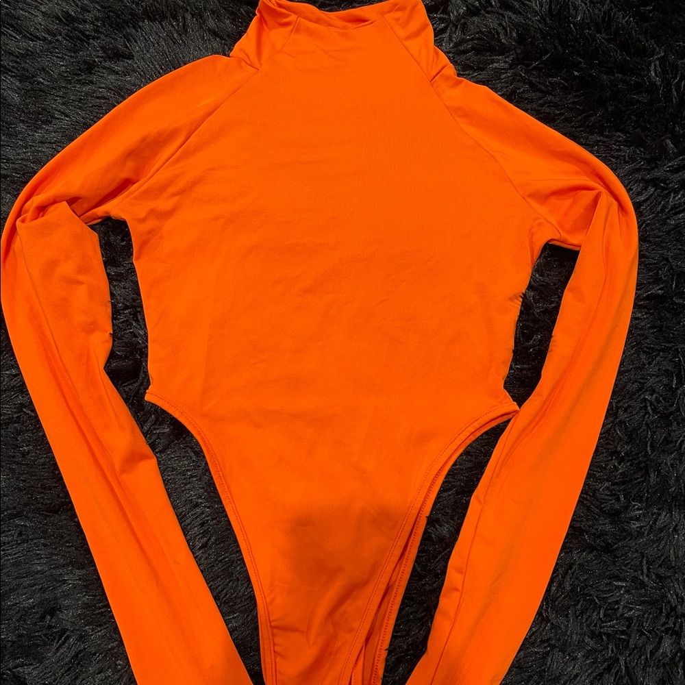 Orange spandex turtleneck bodysuit